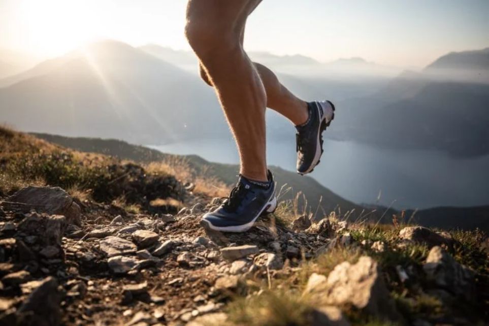 Trail runner on a mountain ridge at sunrise