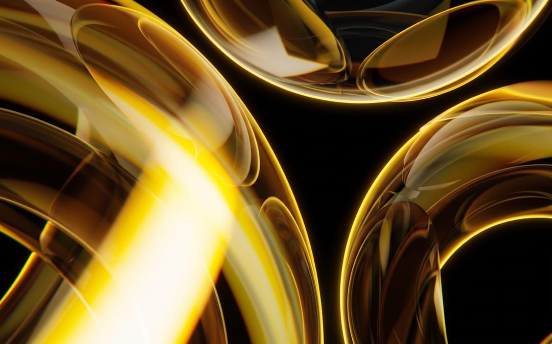 Layered gold glass forms refracting warm light